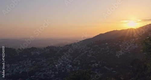 Mesmerizing sunset over Dharamshala, North India, known as the hometown of the Dalai Lama. Experience the tranquil evening ambiance in this captivating shot. photo