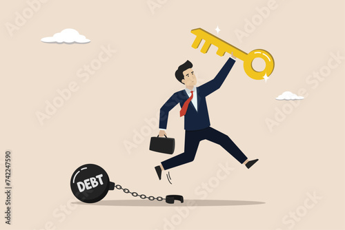 Debt free or freedom for pay off debts, solution to solve financial problem, investment to break free, happy businessman holding golden key after unlock debt burden chain.