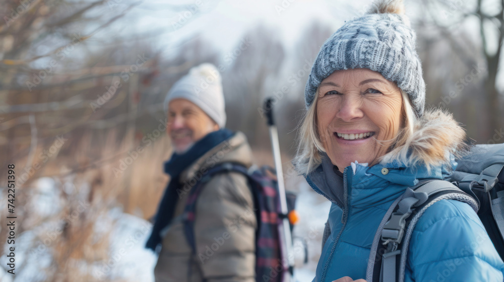 Portrait cheerful smiling middle age woman hiking walking with her husband enjoying free time and nature. Active beautiful seniors in love together at winter day