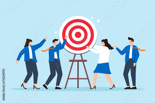 Business team constructing a target board together