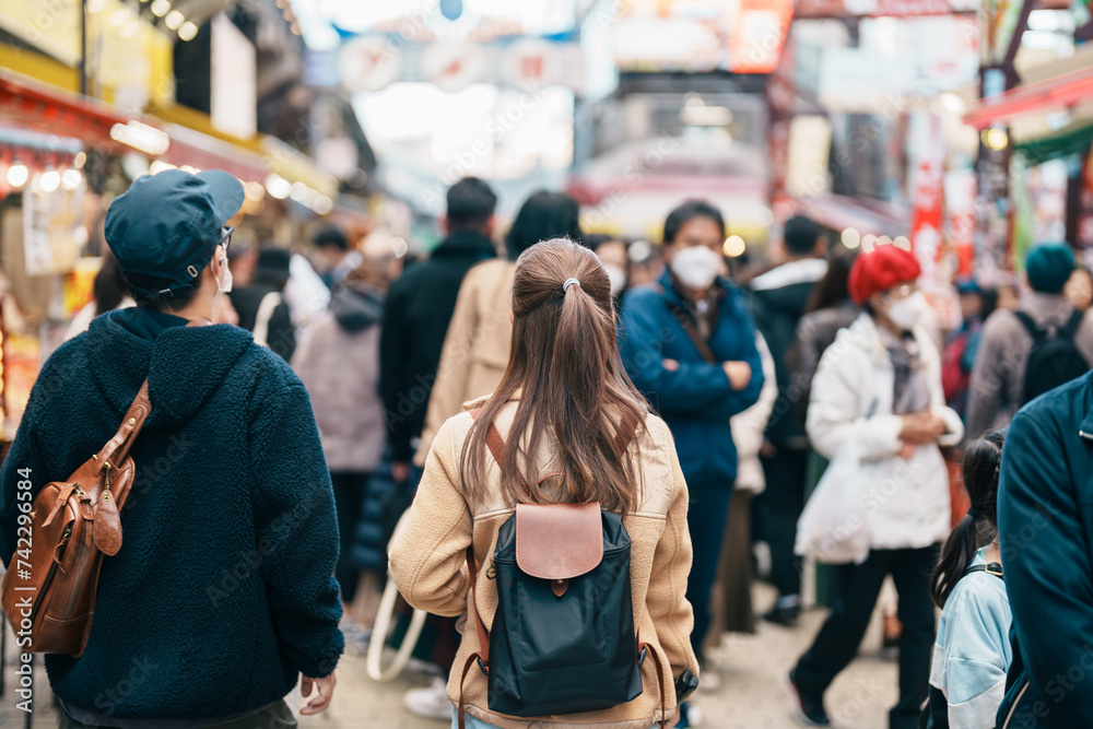 Tourist woman visit Ameyoko market, a busy market street located in Ueno. Landmark and popular for tourist attraction and Travel destination in Tokyo, Japan and Asia concept