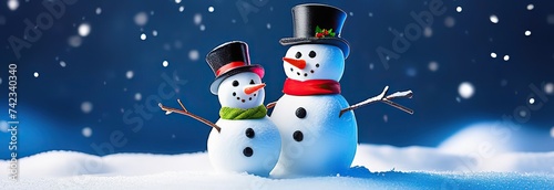 Adorable and happy snowman family on Christmas snowy background, get together and celebrating holiday seasons, with copy space, idea for greeting cards and posters © Kseniya Ananko