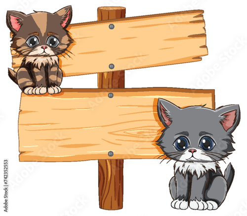 Two adorable kittens sitting by a signpost.