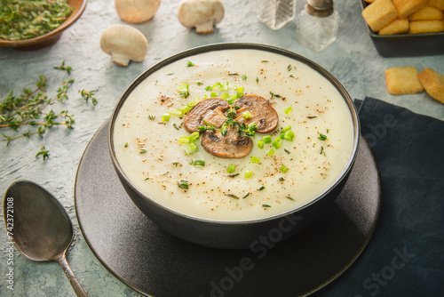 Middle Eastern creamy mushroom soup. A warm bowl of delicious creamy soup with tender bites of mushroom pieces. Served with crispy croutons. photo