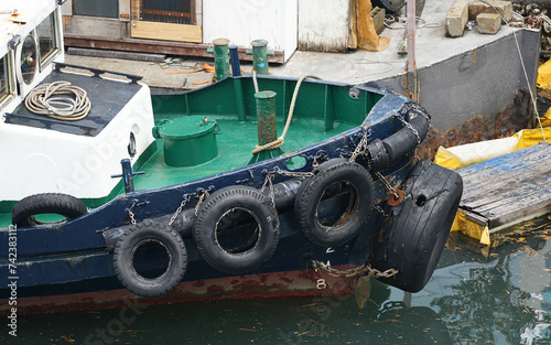 An old workboat docked at a pier in the port of Yokohama, Japan photo