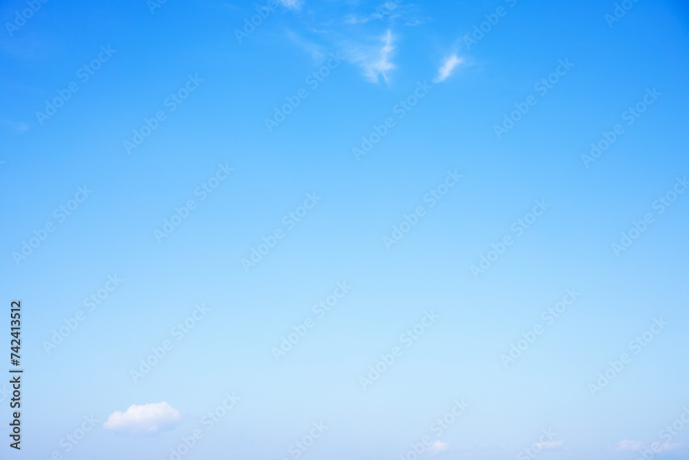 Blue sky background and white clouds soft focus, and copy space horizontal shape.