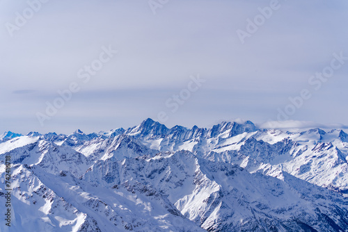 Scenic view of mountain panorama with snow covered mountain peaks in the Swiss Alps at mount Titlis on a sunny winter day. Photo taken February 21st, 2024, Titlis, Engelberg, Switzerland. © Michael Derrer Fuchs