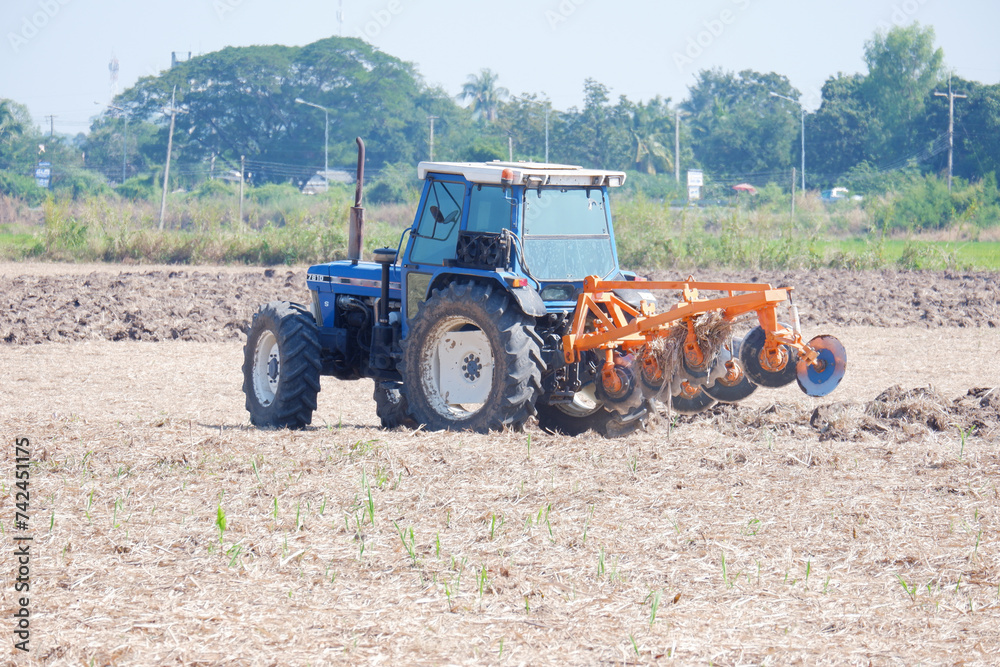 Farmers drive tractors to plow the soil for farming. Farmers drive tractors to plow the soil for farming.