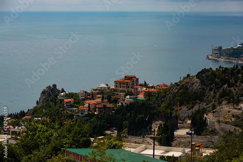 Bird's eye view of a small mountain village and the sea.