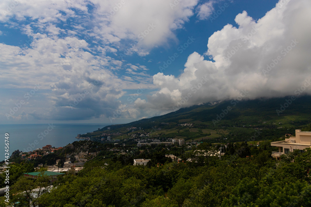 Rain clouds over the mountain range and the sea. Scenery