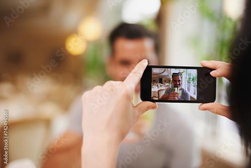 Restaurant, picture and couple with smartphone, screen and connection with mobile user and photograph. Date, man and woman with cellphone or digital app for memory and romance with Valentines day