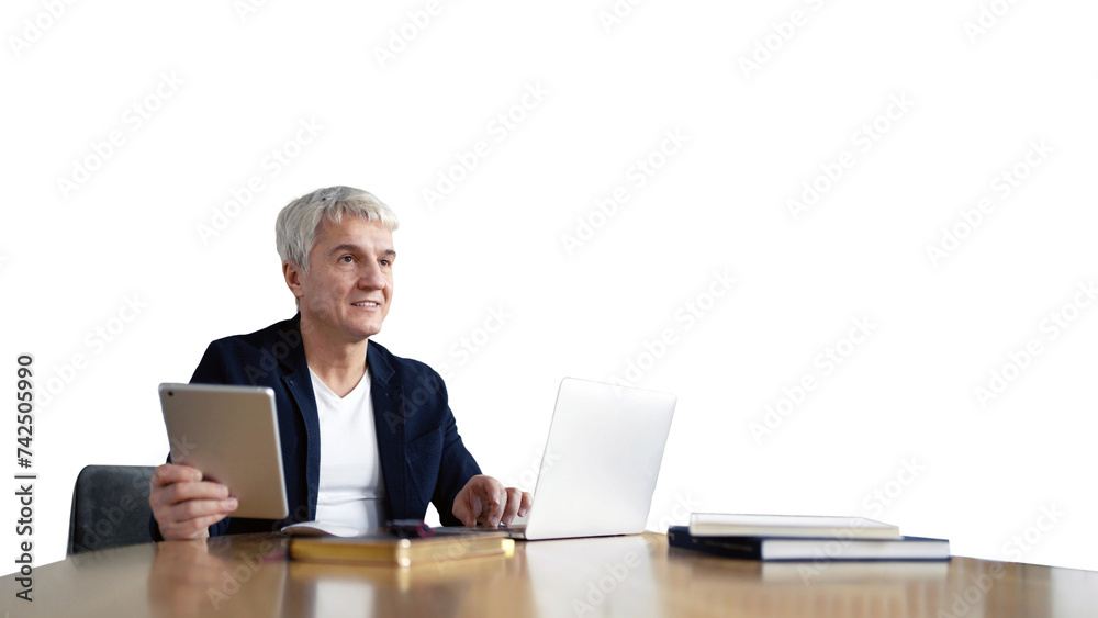 An elderly man, with graying hair, uses a laptop in the office of a worker.
An elderly man, with graying hair, uses a laptop in the office of a worker.