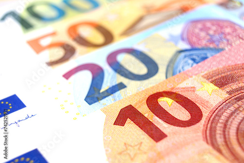 Euro Banknotes of 10, 20, 50 and 100 euros, lying one on top of the other, close up.