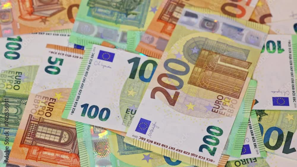 Different euro banknotes in slow rotation as background Different euro banknotes in slow rotation as background