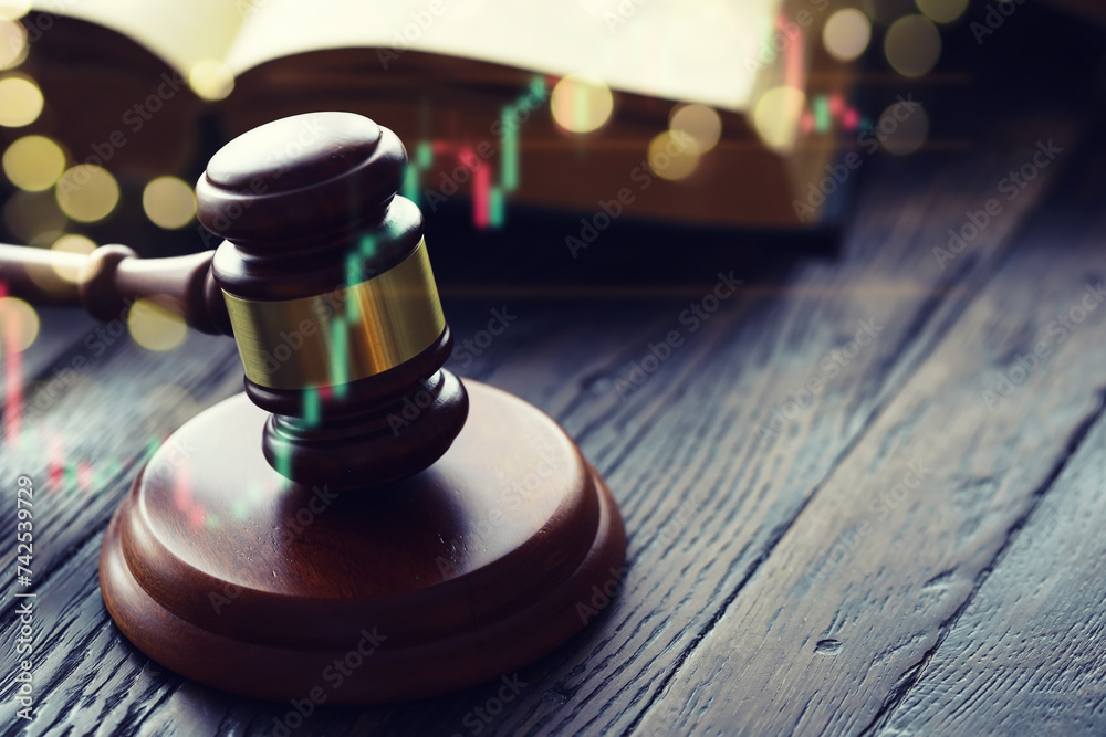 Wooden judge gavel and legal book on wooden table