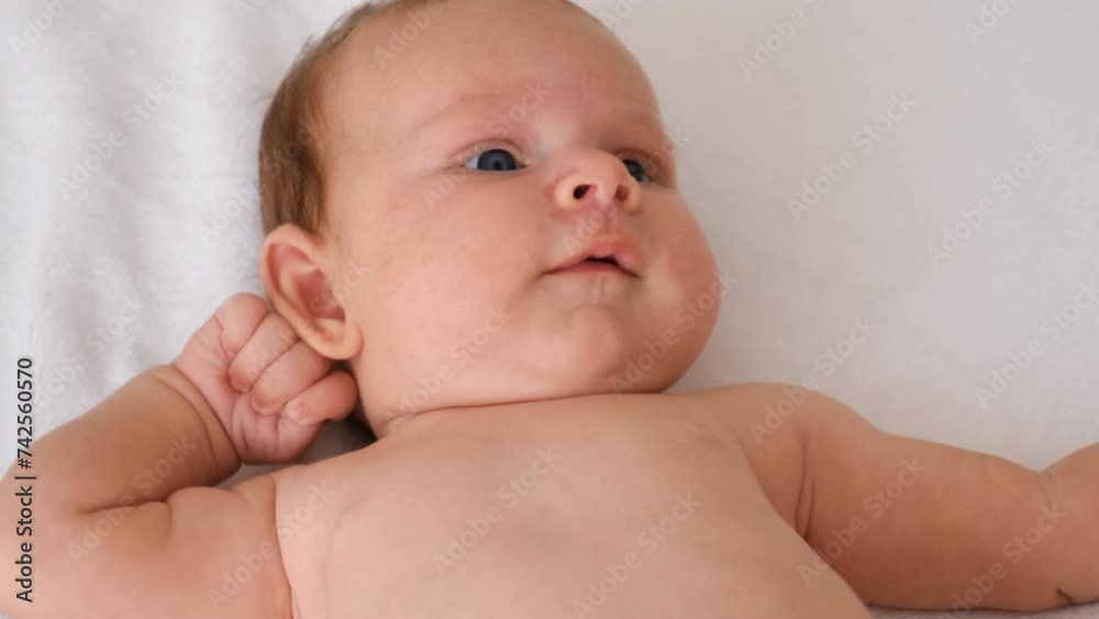 mom plays with baby in her arms. selective focus. mom plays with baby in her arms. selective focus.