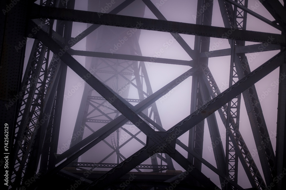 Iron structures of the The Dom Luis I Bridge in thick fog, Porto, Portugal.