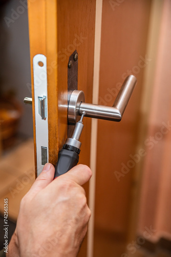 craftsman uninstalling a panel or door mounting, maybe key escutcheon photo