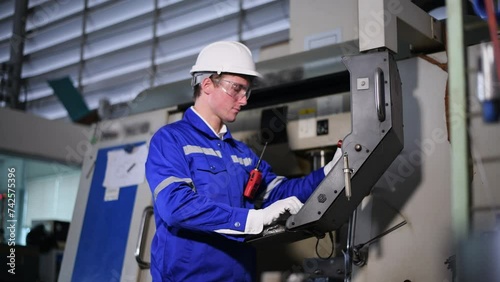 Industry engineer worker wearing safety uniform control operating computer controlled Lathe grinding machine working in industry factory is metal manufacturing industry concept	
 photo