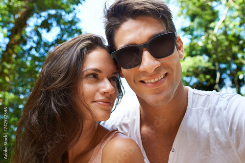Happy, love and portrait of couple in park for bonding, relationship and relax outdoors together. Nature, dating and man and woman on holiday, vacation and weekend for travel, wellness and adventure © M Moller/peopleimages.com