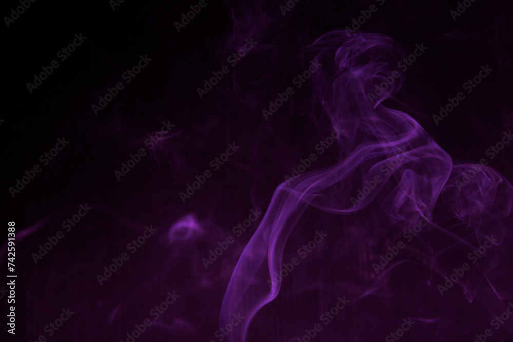 Shapeless purple light on black background used as wallpaper