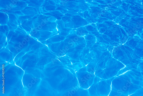 The light reflects blue in the water in the swimming pool. It looks fresh and lively  suitable for use as a wallpaper.