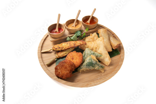Thai appetizer with thai roll, shrimp cake, chicken satay, vegetable samosa, crispy sea bass and shrimp wanton isolated on white