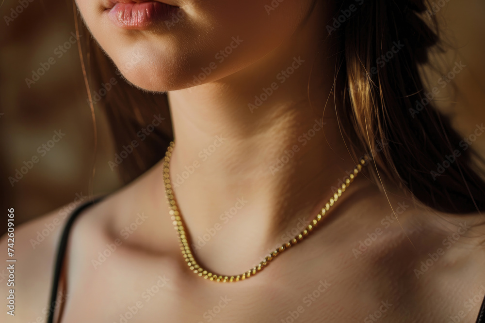A young woman wearing an elegant golden necklace