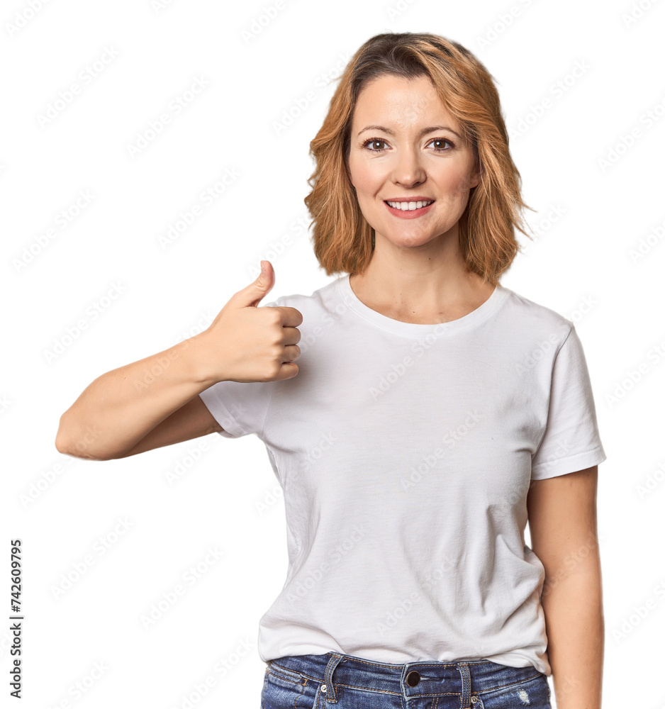 Blonde middle-aged Caucasian woman in studio smiling and raising thumb up Blonde middle-aged Caucasian woman in studio smiling and raising thumb up