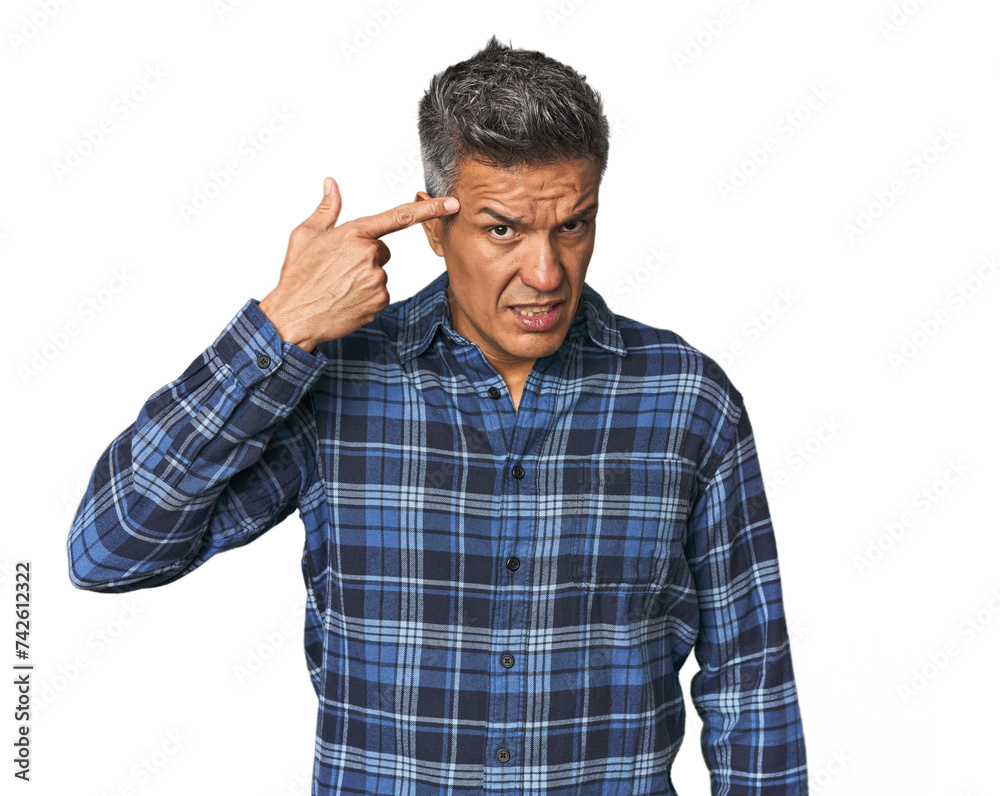 Middle-aged Latino man showing a disappointment gesture with forefinger. Middle-aged Latino man showing a disappointment gesture with forefinger.