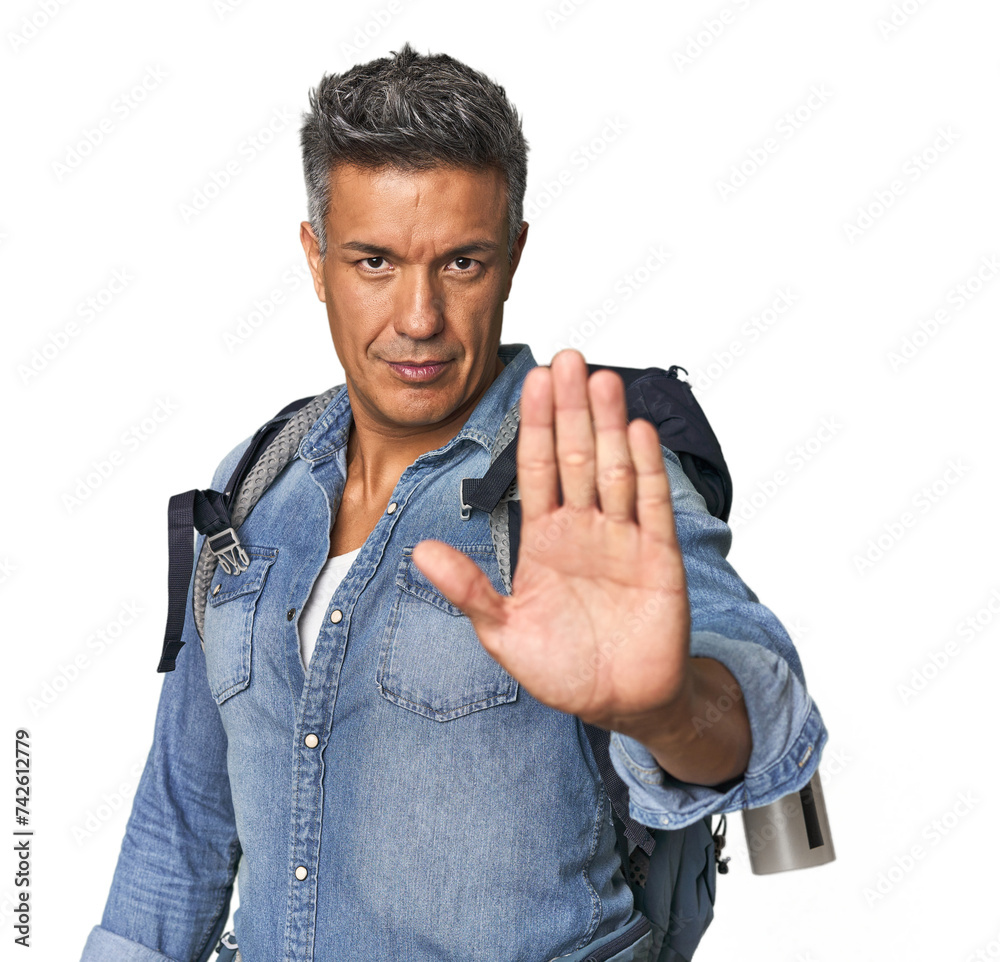 Hispanic hiker with backpack and flask standing with outstretched hand showing stop sign, preventing you. Hispanic hiker with backpack and flask standing with outstretched hand showing stop sign, preventing you.