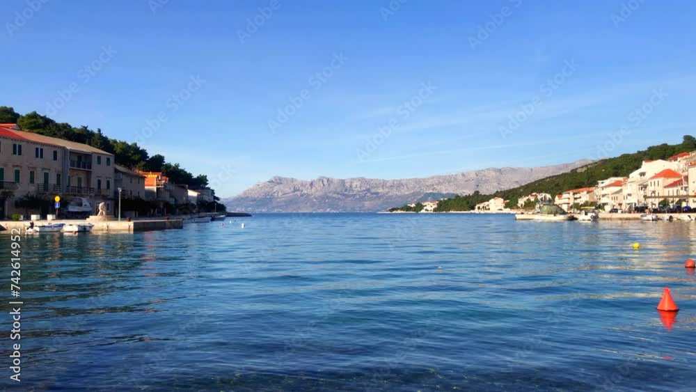 Seaside village. Ocean and mountain views. Adriatic coast. View of the harbor and stone buildings in the beautiful town of Povlja, Brac Island, Croatia. Europe. Seaside village. Ocean and mountain views. Adriatic coast. View of the harbor and stone buildings in the beautiful town of Povlja, Brac Island, Croatia. Europe.