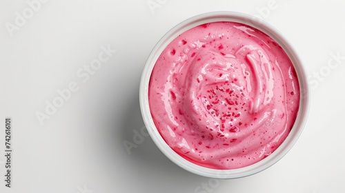 Bowl of strawberry yogurt isolated on white background from top view