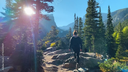 Woman hiking through Rocky Mountain National Park in Colorado