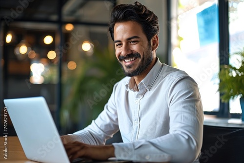 Happy young Latin business man looking at laptop at work. Smiling businessman professional employee, company manager using computer sitting at desk managing digital data in, Generative AI