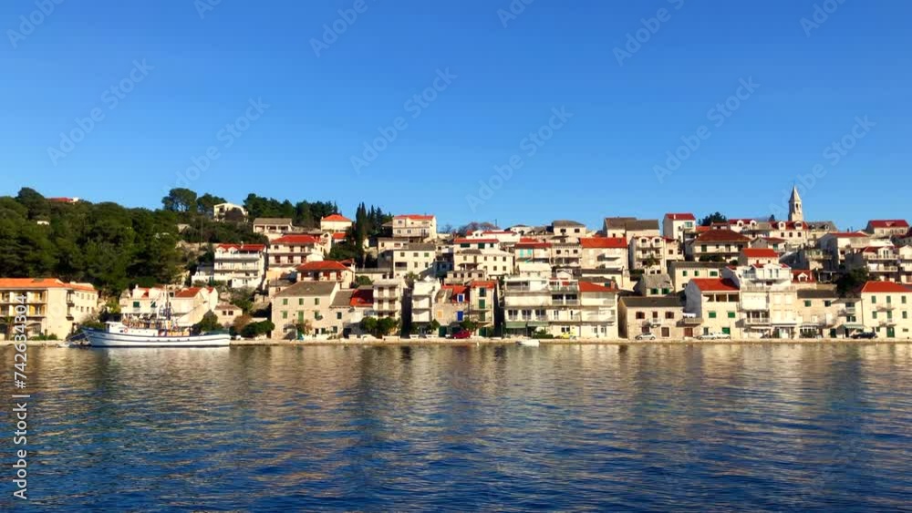 Seaside town at sunset. Coastal village on the Adriatic coast. Harbor views with stone buildings in the beautiful town of Povlja, Brac Island, Croatia. Europe. Seaside town at sunset. Coastal village on the Adriatic coast. Harbor views with stone buildings in the beautiful town of Povlja, Brac Island, Croatia. Europe.