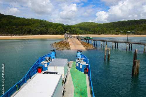 Kingfisher Bay ferry arriving on Fraser Island (K'gari) with passengers and vehicles in Queensland, Australia photo