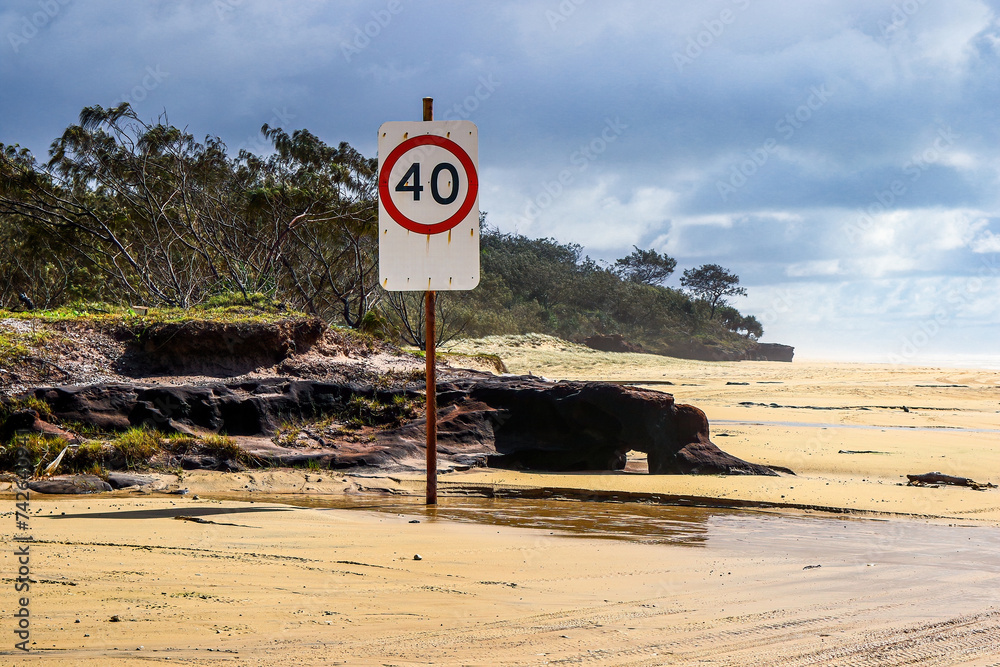 Speed limit sign on the sandy highway of the 75-mile beach on the east coast of Fraser Island, Queensland, Australia