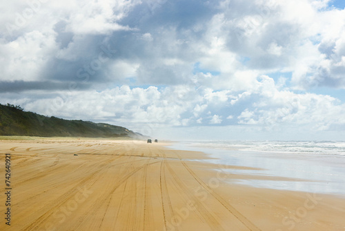 4-wheel drive pickups travelling on the sandy highway of the 75-mile beach on the east coast of Fraser Island, Queensland, Australia photo