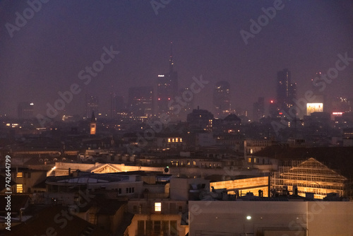 Milan - February 2024 - Milan modern city skyline in smog fog - High Levels air pollution - Night