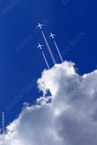 three white passenger airplanes in blue sky
