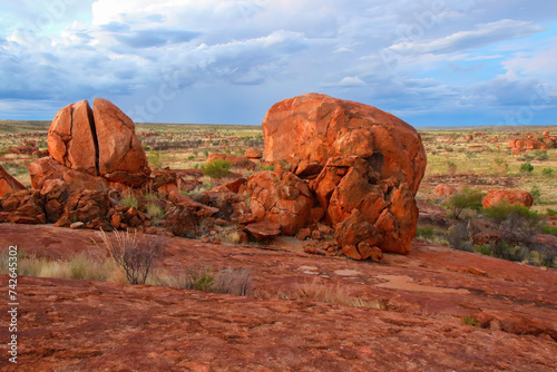 Devils Marbles (Karlu Karlu in Aboriginal language) at dusk in the Australian Red Center, Northern Territory - Granite boulders formed by erosion and natural weathering in bushland photo