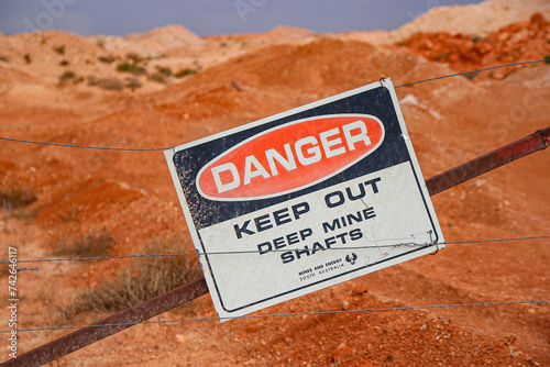 Danger sign outside Tom's Working Opal Mine in Coober Pedy, South Australia - Warning of deep mine shafts in the Australian desert