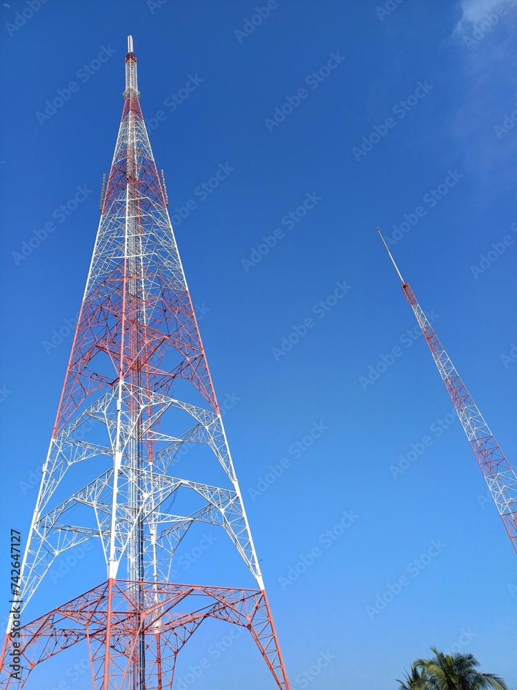 Antenna system for broadcast, telecommunication, television system with blue sky clouds in background Antenna system for broadcast, telecommunication, television system with blue sky clouds in background