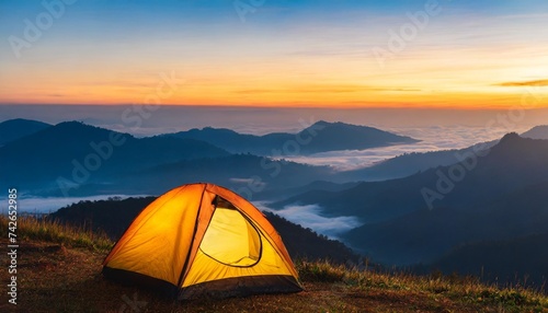camping tent on mountain peak at sunrise travel and vacation concept