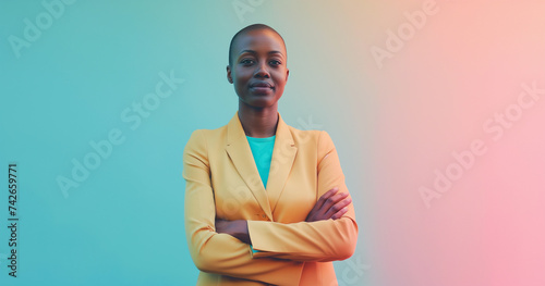 Studio portrait of beautiful bald professional black woman wearing suit with arms crossed, colorful background, boss lady concept