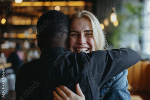 Joyful Embrace: Interracial Friends Hugging in Cozy Cafe Environment