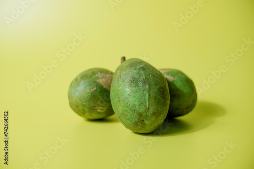 Kedondong or ambarella fruit or otaheite apple or great hot plum fruit on yellow background, tropical fruit photo