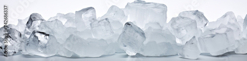 Wide view of a row of ice cubes on a white background.