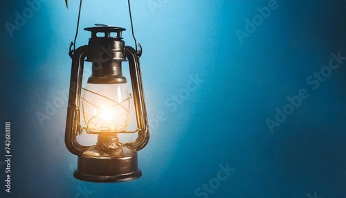 a lantern hangs on a blue background